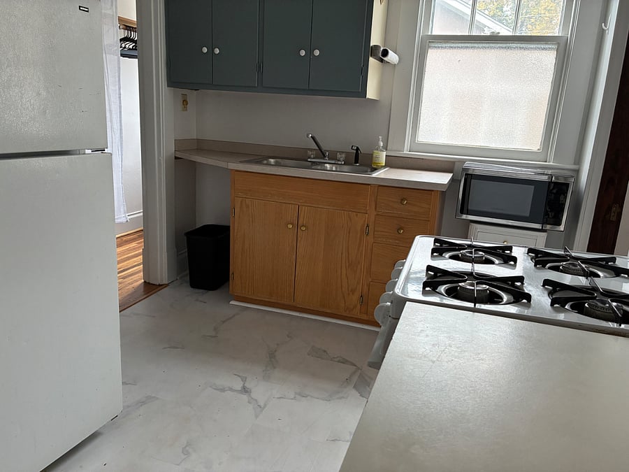 This kitchen has a full-sized refrigerator, four-burner gas stove and plenty of cabinet space.