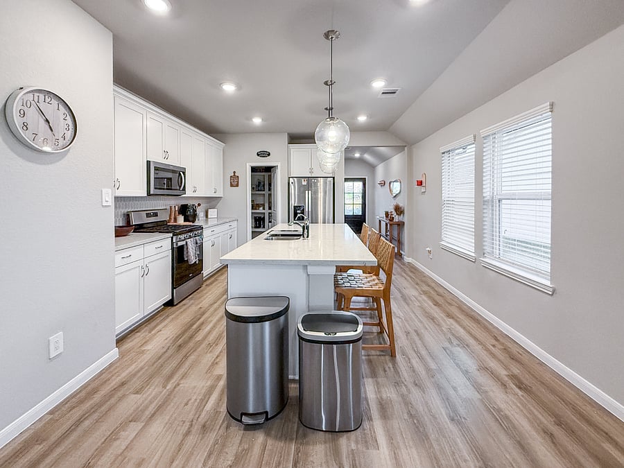 Bright, fully equipped kitchen with a large island, modern appliances, and stylish lighting. Perfect for cooking, gathering, and enjoying meals together in an open, inviting space.