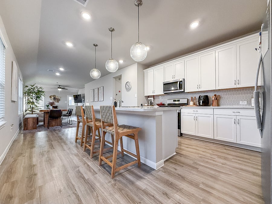 Spacious kitchen with ample counter space, updated appliances, and bright lighting. Ideal for meal prep, coffee mornings, and family-friendly cooking.
