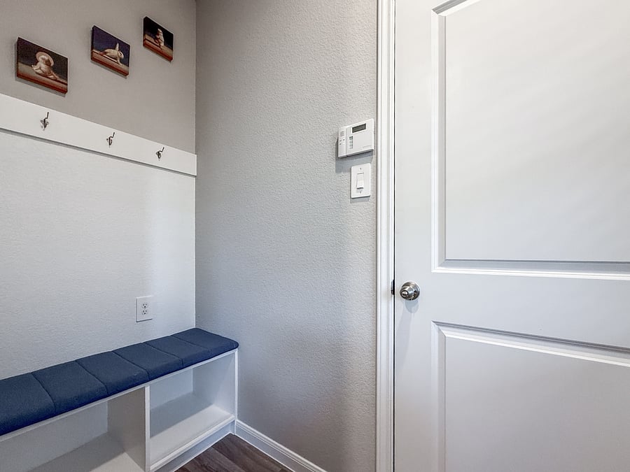 Cozy mudroom corner with bench seating and hooks for easy storage. A clean, organized spot to drop bags, shoes, and settle in comfortably.