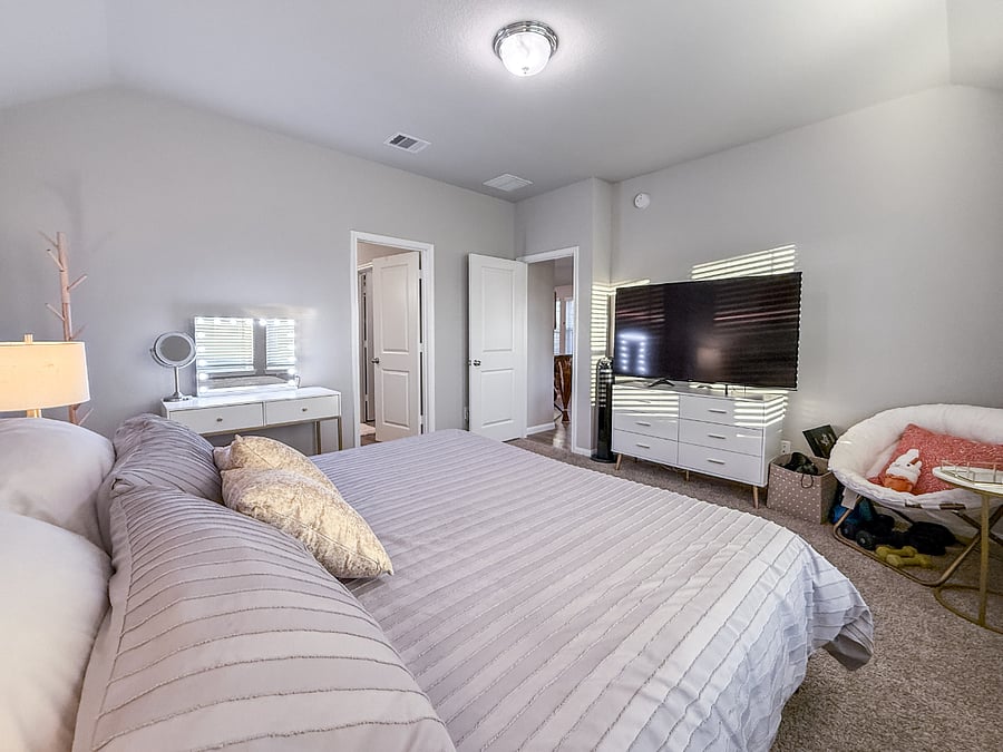 Master suite featuring a king bed, Smart TV, vanity, and direct access to the bathroom. A serene, comfortable space designed for restful nights.