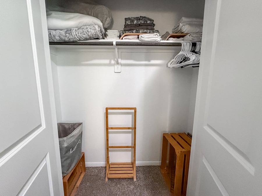 Spacious walk-in closet with organized shelving, hangers, and laundry binsideal for long stays or guests who love extra storage.