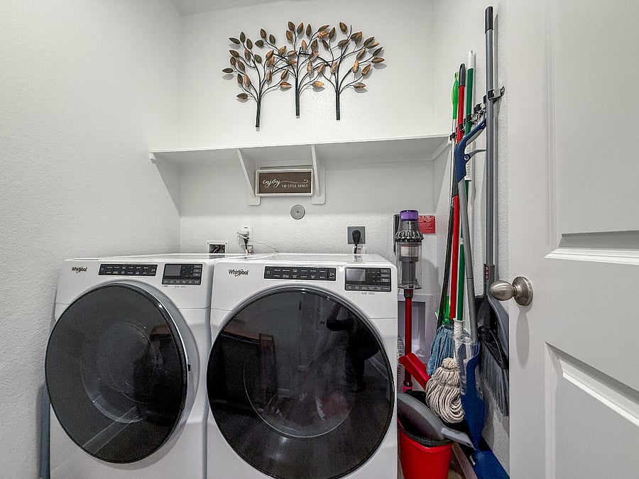 Full laundry room with high-capacity washer and dryer, plus cleaning tools and suppliesperfect for extended stays and added comfort.