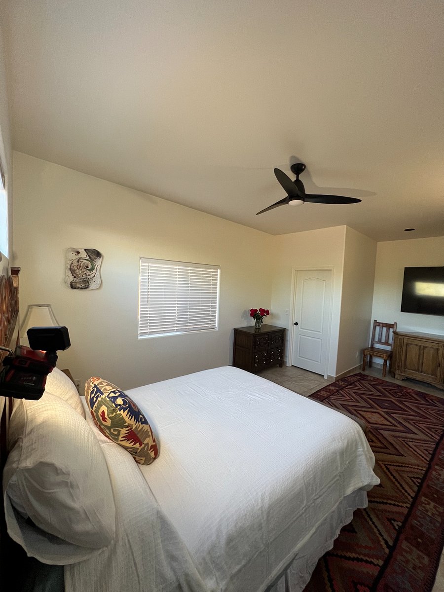 Primary bedroom with original artwork hung on the wall 
