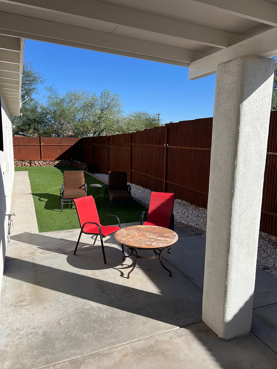 Side yard patio featuring outdoor furniture and 8 steel fencing for privacy and security.