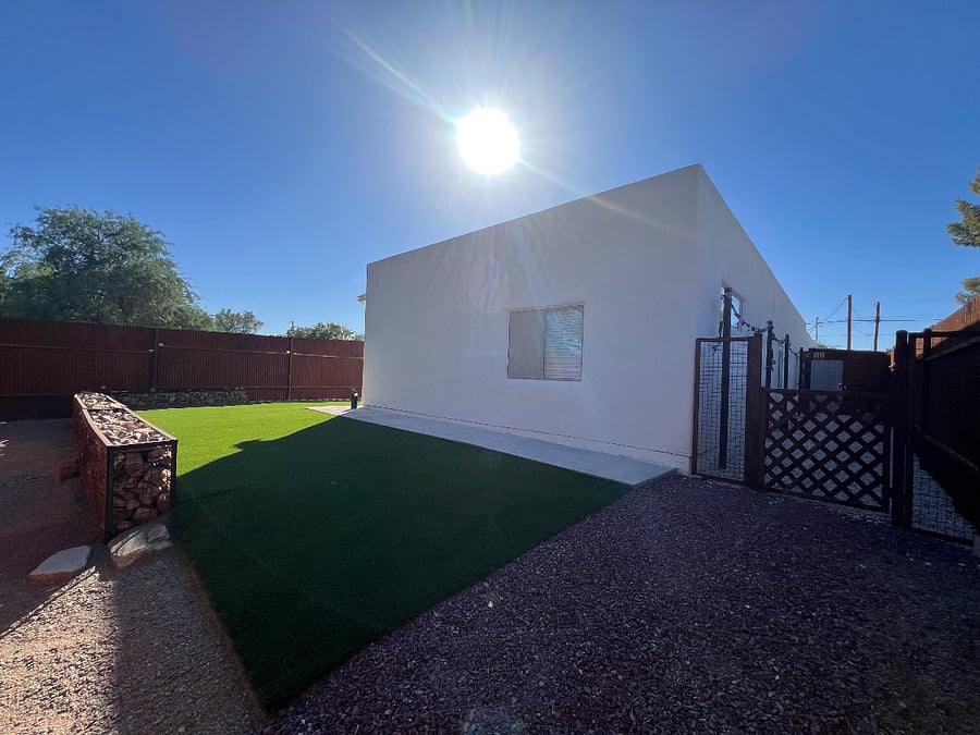 East side of backyard, hardscaped with artificial turf perfect for playing corn hole or bocce ball games