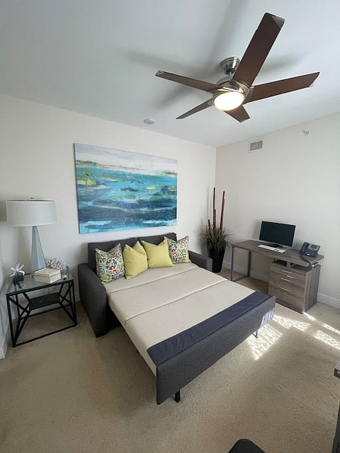 Guest bedroom featuring a Queen-size Destiny Sleeper and dedicated office desk with printer 