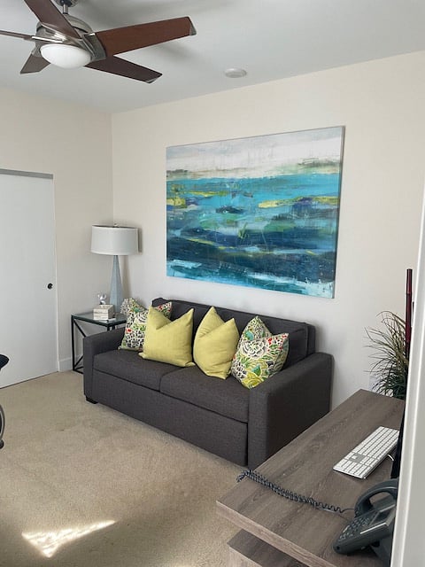 Guest bedroom featuring a Queen-size Destiny Sleeper and dedicated office desk with printer 