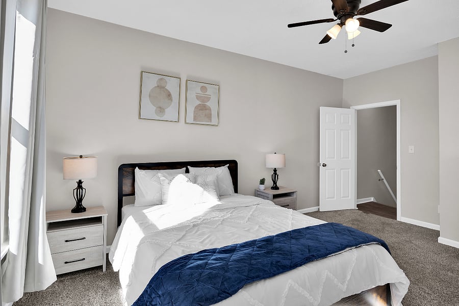 Second bedroom with comfortable queen bed, spacious closet area, and blackout curtains.