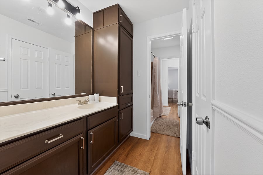 Private vanity with extensive storage, direct from primary bedroom