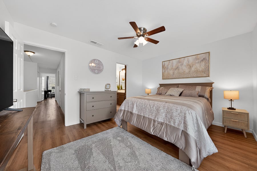 Second queen bedroom with smart TV and ceiling fan