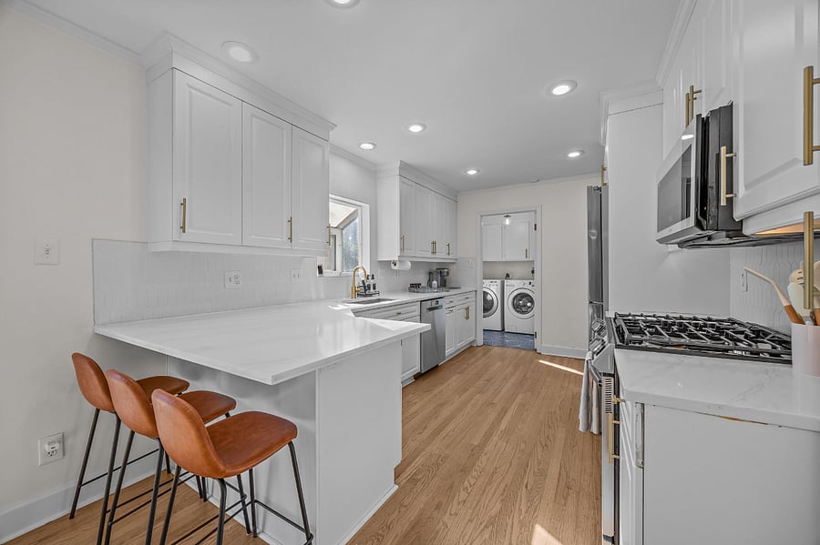 Kitchen with breakfast eating area and barstools. Connects to the laundry room with a door to separate.
