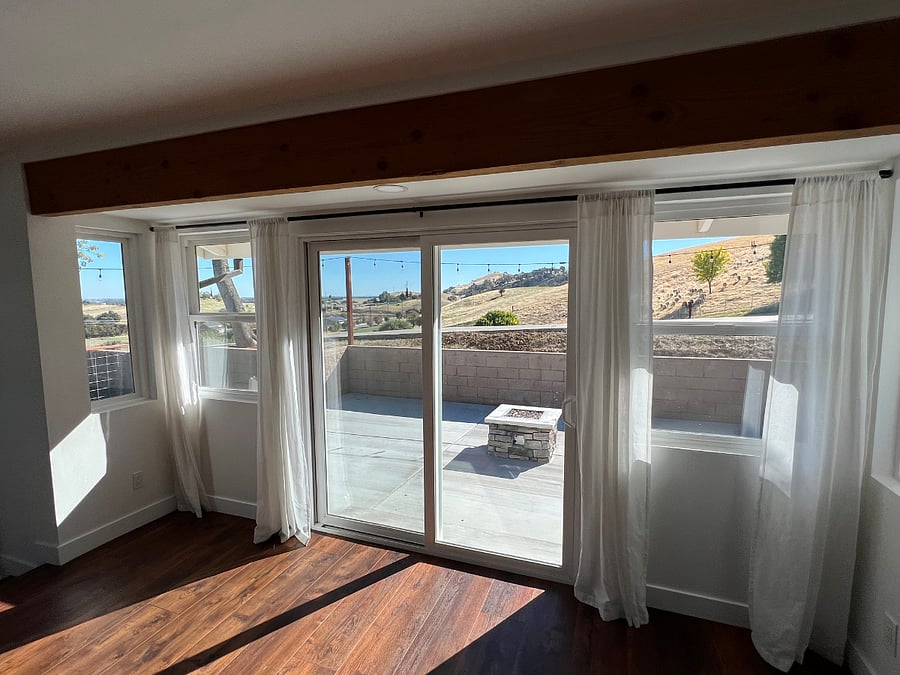 Dining room looking out at side patio through sliding glass doors.