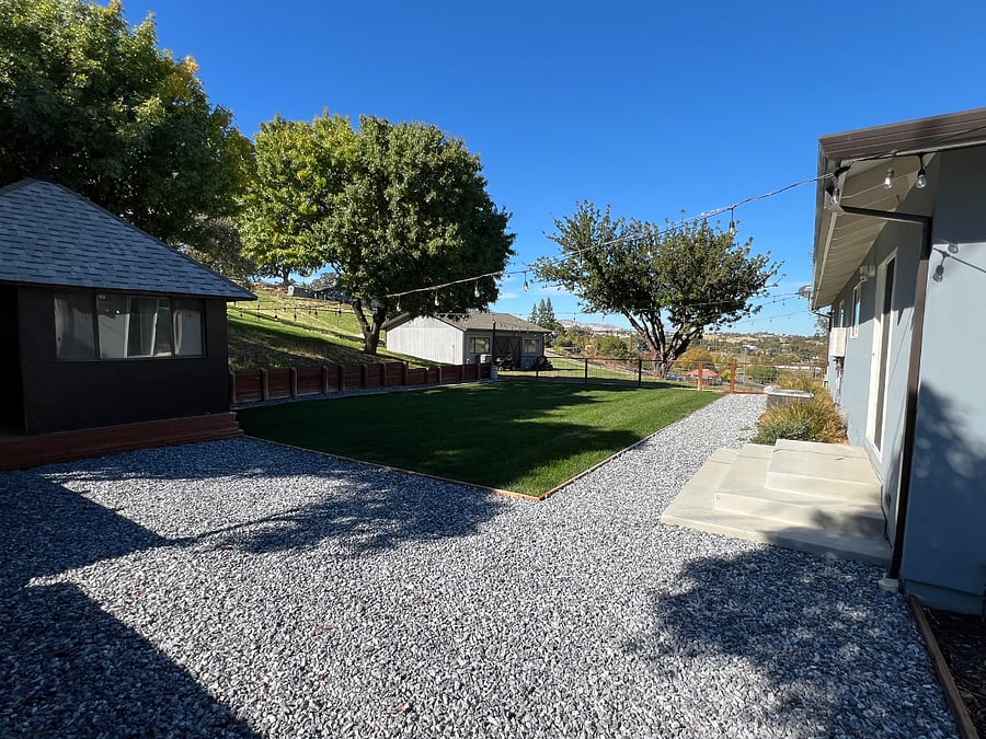Backyard tool shed, and equipment garage in the distance.