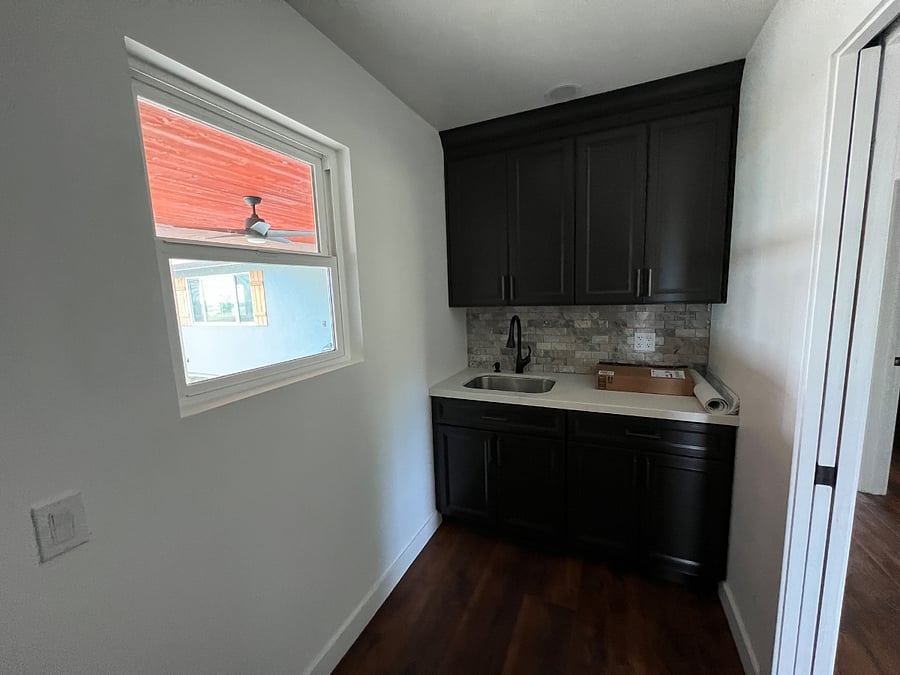Laundry room, cabinets and sink.