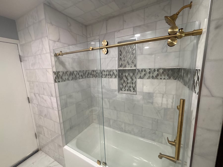 Private new Shower tub with marble tile, gold trim accessories