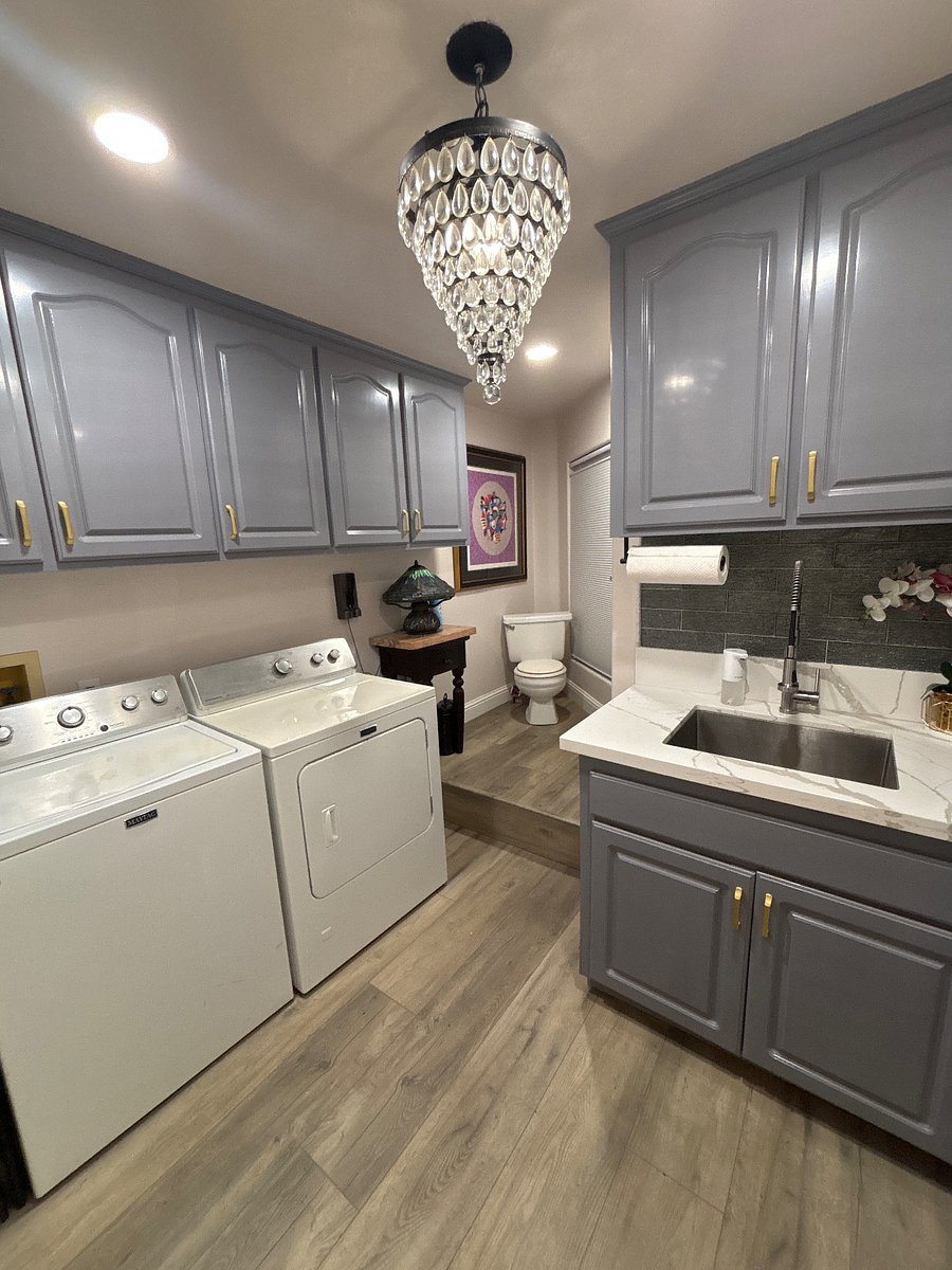 Laundry room right off the kitchen. Room has appliances, storage cabinets , cleaning supplies & personal storage