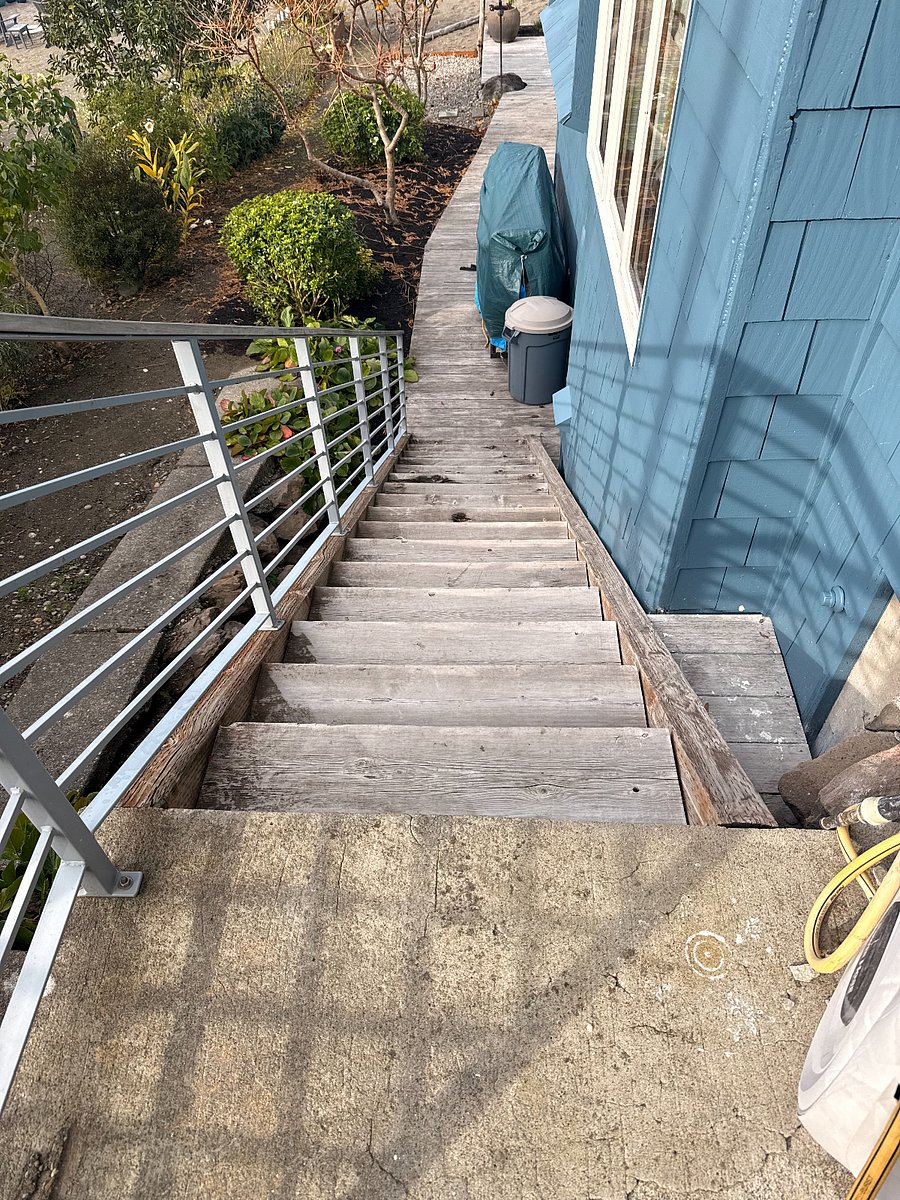 Stairs from carport down to apartment entrance