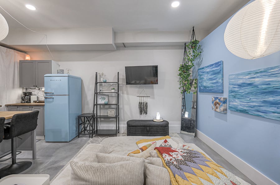 Relax in a cozy living room with soft seating and smart TV.