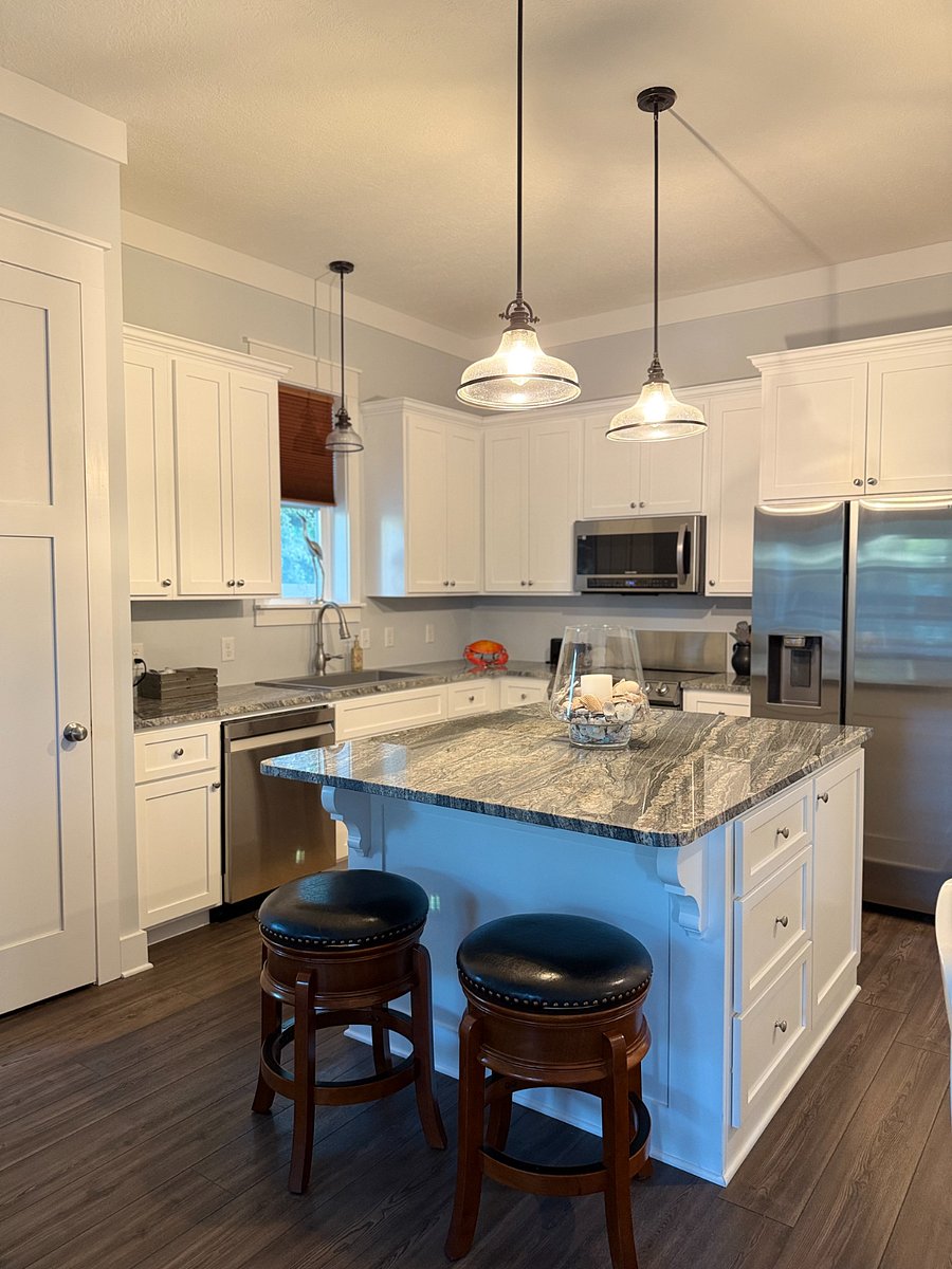 Kitchen has granite counter tops and stainless