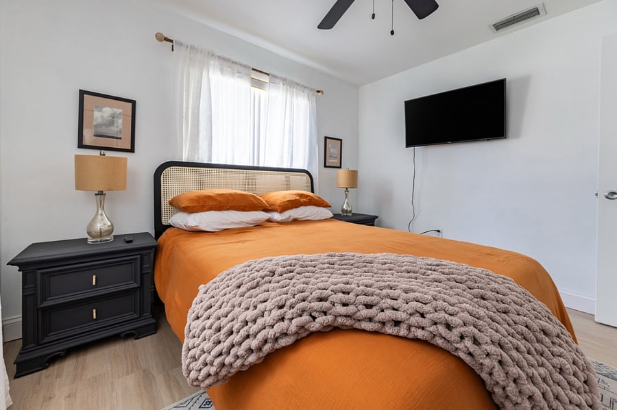 Second bedroom with queen-sized bed and Smart TV.