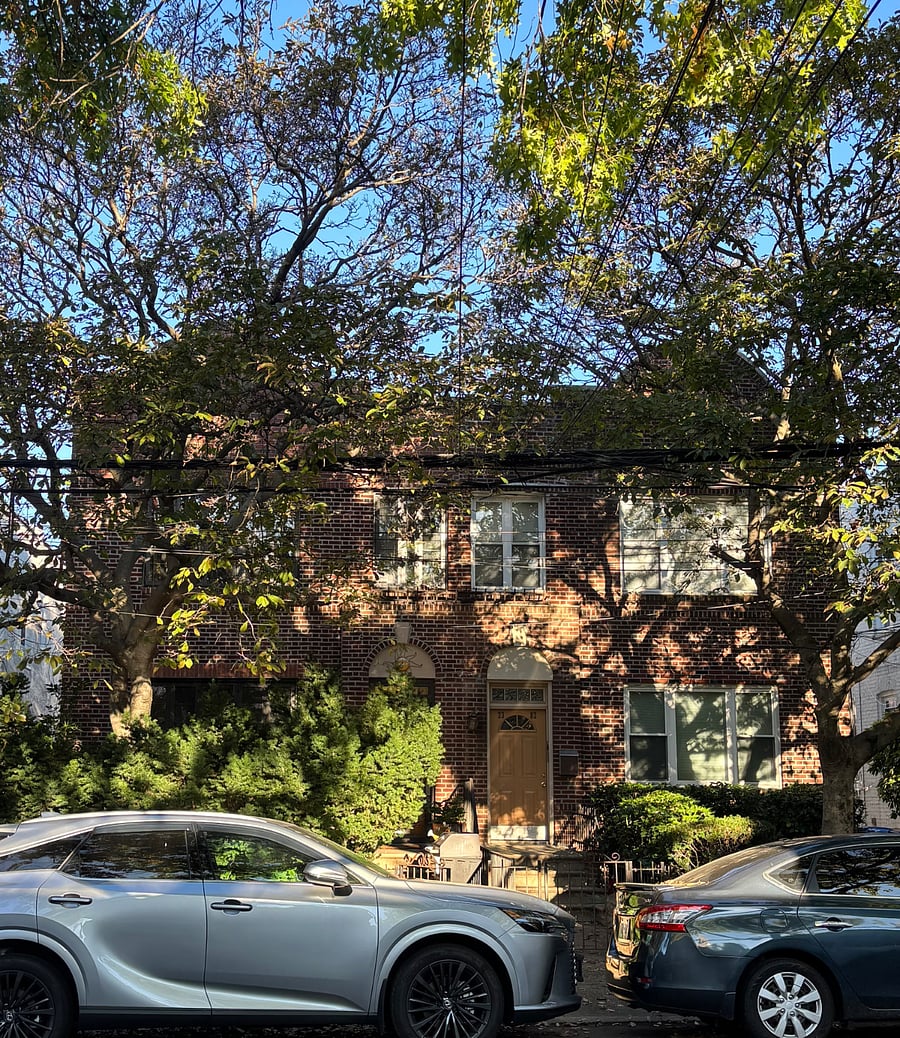 The block is made up of 1920s row houses, with many trees