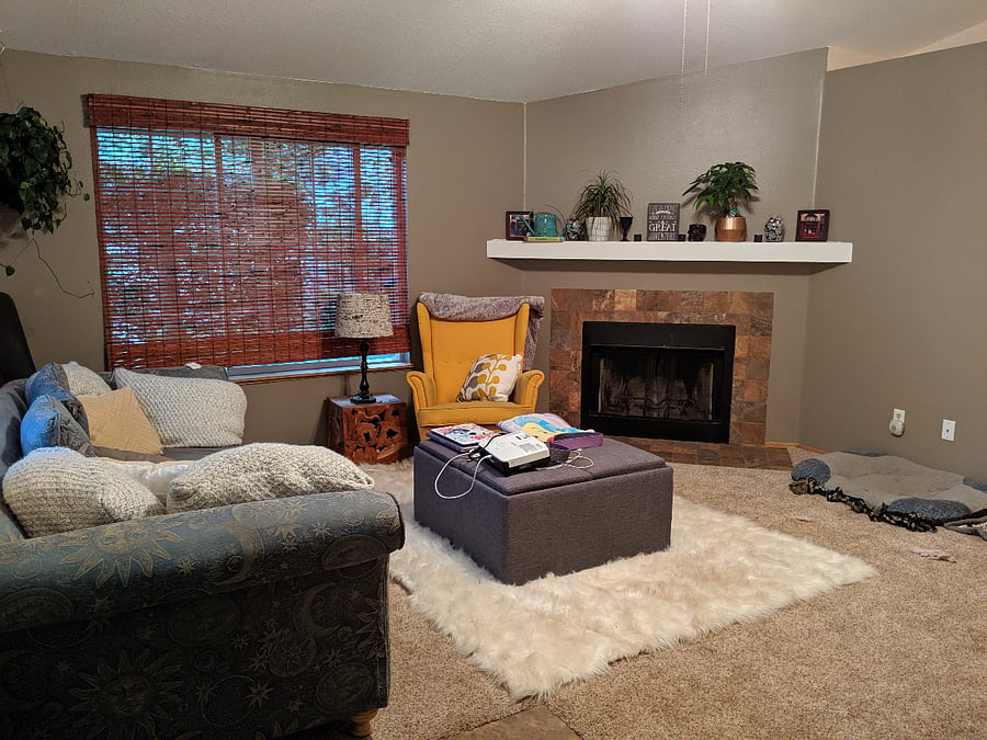 Spacious living area featuring a wood fireplace, perfect for warmth and ambiance.