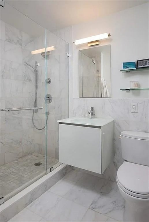 Modern bathroom with full tub, shower, and fresh linens provided.