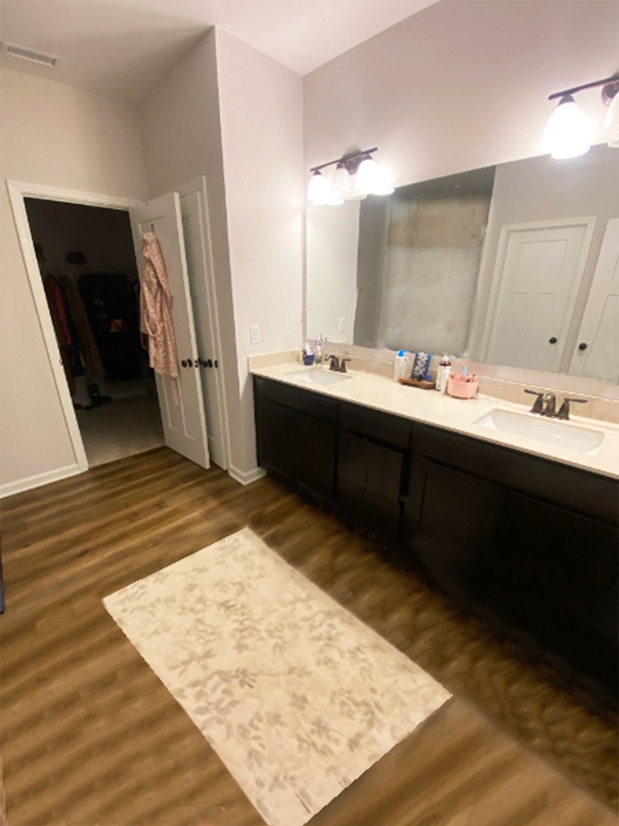 Master bath featuring large mirror w double sinks 