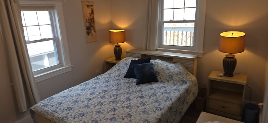 Queen bedroom, 2 nightstands, bureau with large mirror, closet with shor rack and hamper, 2nd closet with shelves, 2 windows with blackout curtains.