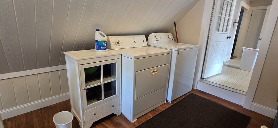 Washer and dryer located in entry room. Door into the kitchen.
