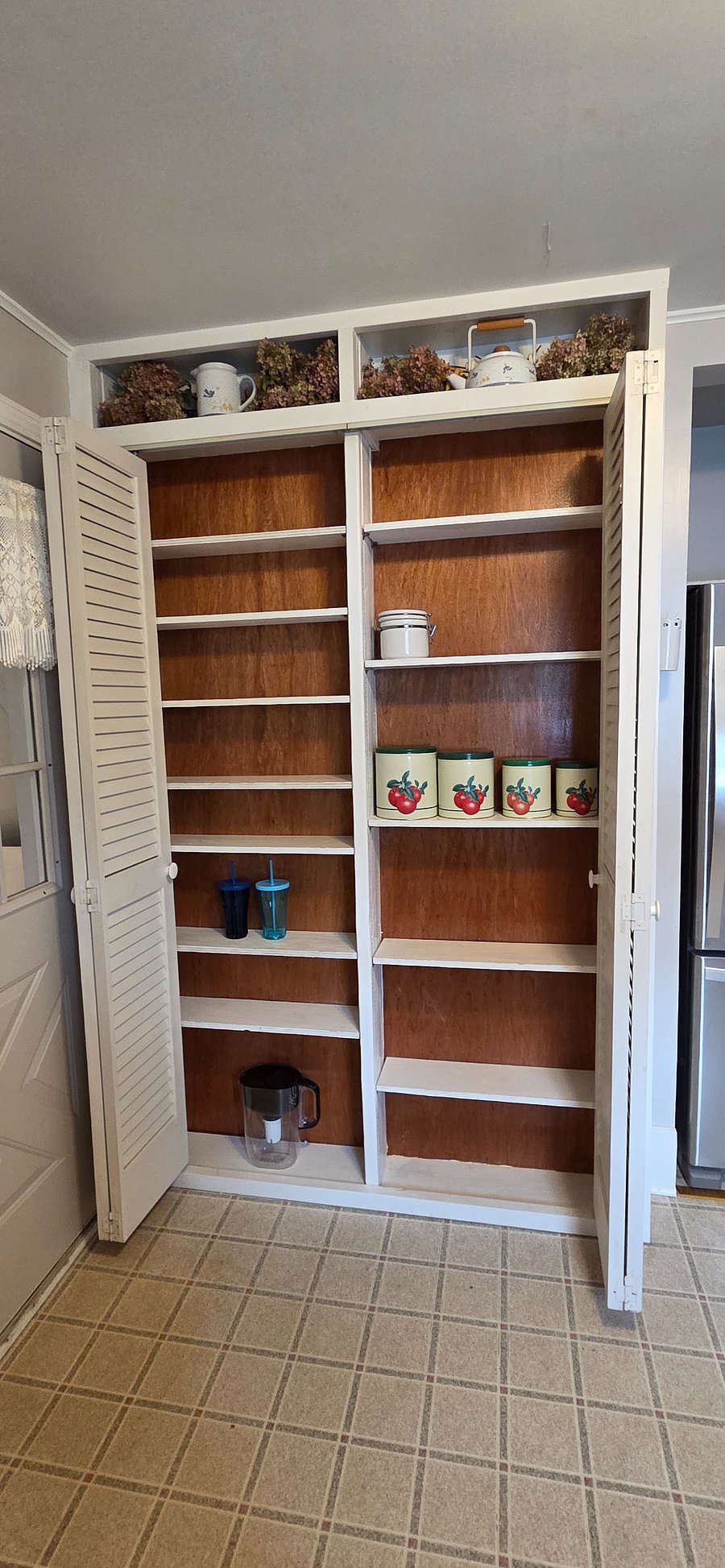 Kitchen pantry with lots of storage and canister set.