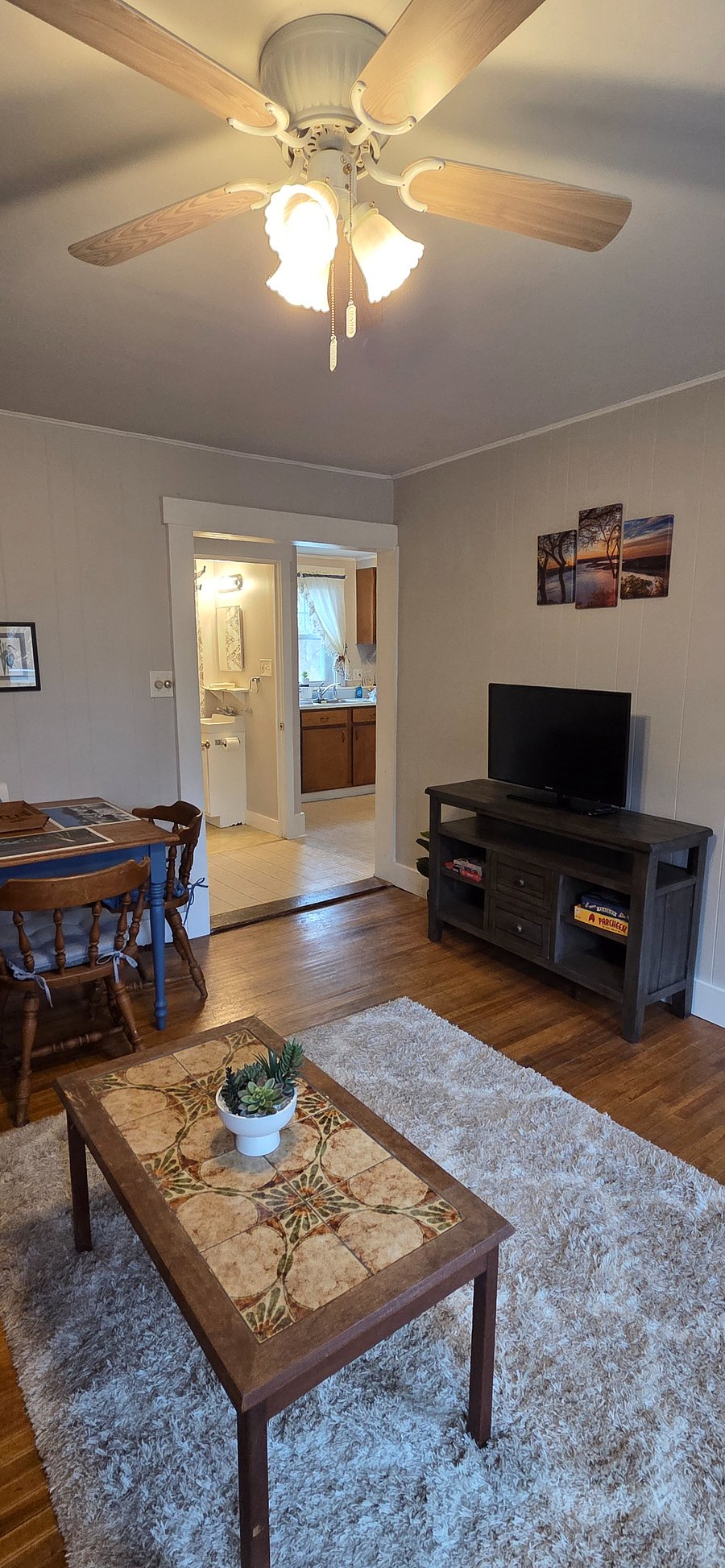TV on stand with card games and puzzles.