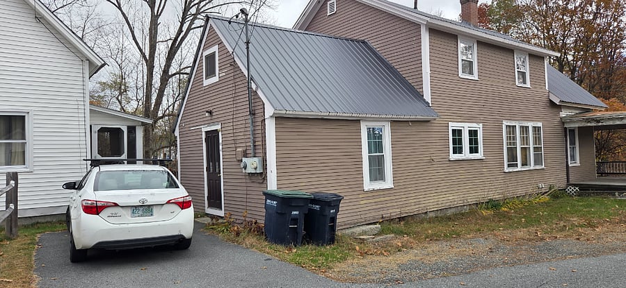 Two parking spots next to entry door. Private entry with solar lights and rain guand over the door. Trash and recycling cans.