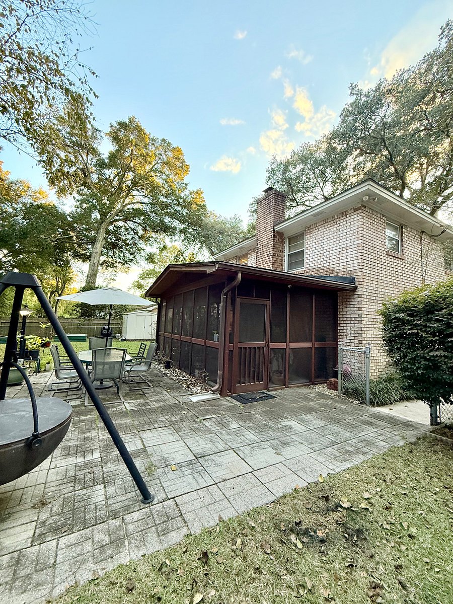 Big Backyard with Cowboy Cauldron, Fire Pit/Grill, and Patio with seating and umbrella