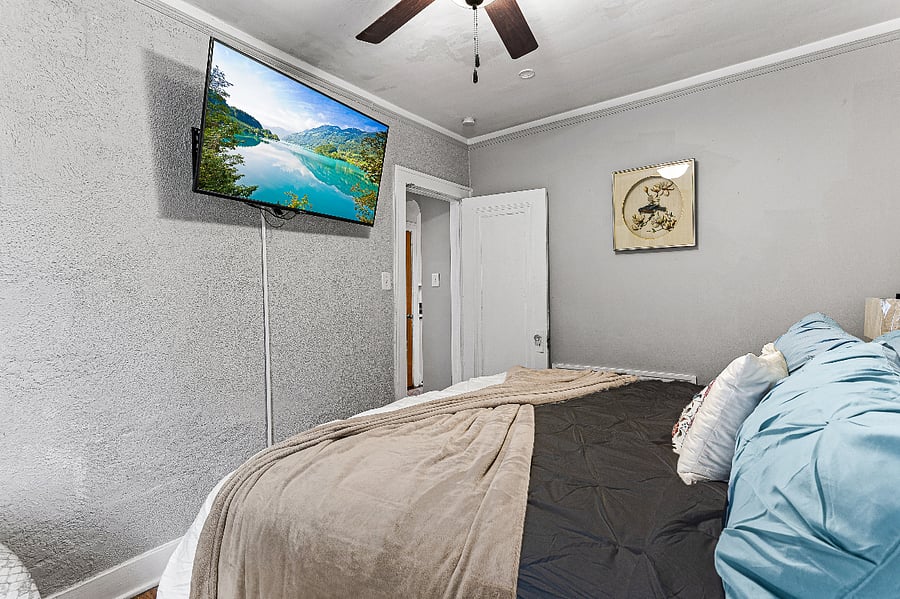 Apt. A Lower Flat Bedroom 2.  50 Smart TV, Roku.  Flexible bedding arrangement.  It can be arranged as a king width bed or it can be arranged to have two separate twin beds with fully encased magnetic therapy mattresses, new encased pillows, new bedding, blackout curtains, vertical blinds, large walk-in closet, dresser, touch lamp with charging station, ceiling fan, dresser, large mirror on closet door.