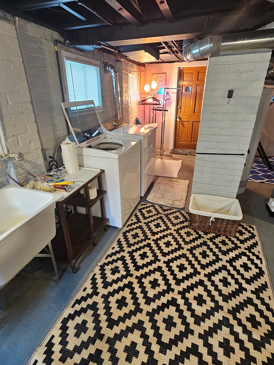 Private laundry center.
Bright basement with large windows allows for lots of natural light, brand new high efficiency washer & dryer.  Ironing board & new iron.  Large utility sinks & a clothing rack to hang laundry.