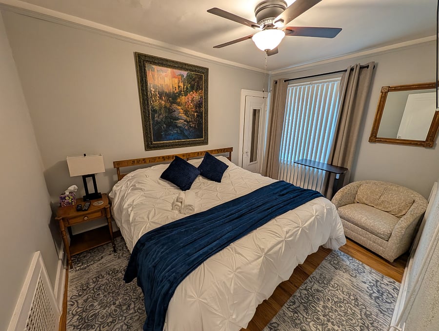 Apt. A Lower Flat Bedroom 2. 50 Smart TV, Roku. Flexible bedding arrangement. Bed dimensions are 76 wide x 75 long.
It can be arranged as a king width bed or it can be arranged to have two separate twin beds with fully encased mattresses, new encased pillows, new bedding, blackout curtains, vertical blinds, large walk-in closet, dresser, touch lamp with charging station, ceiling fan with light, dresser with attached mirror, large mirror on closet door.
