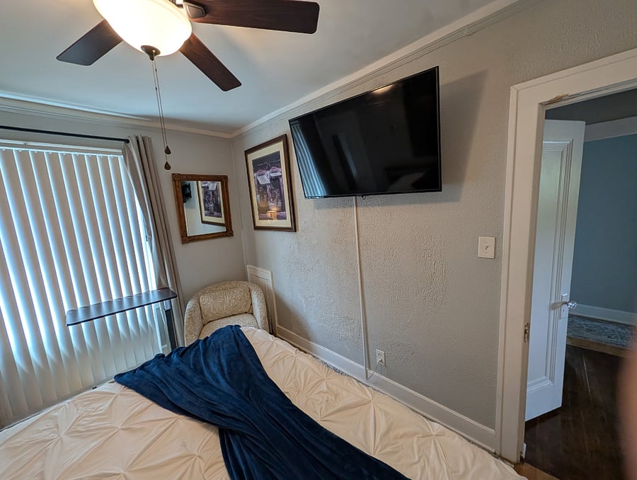 Apt. A Lower Flat Bedroom 2. 50 Smart TV, Roku. Flexible bedding arrangement. Bed dimensions are 76 wide x 75 long.
It can be arranged as a king width bed or it can be arranged to have two separate twin beds with fully encased mattresses, new encased pillows, new bedding, blackout curtains, vertical blinds, large walk-in closet, dresser, touch lamp with charging station, ceiling fan with light, dresser with attached mirror, large mirror on closet door.