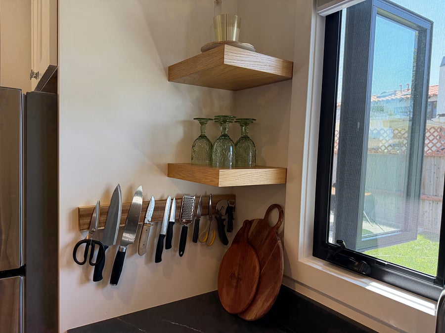 kitchen that is well stocked, with large window over sink opens up to ocean breeze and back yard grass
