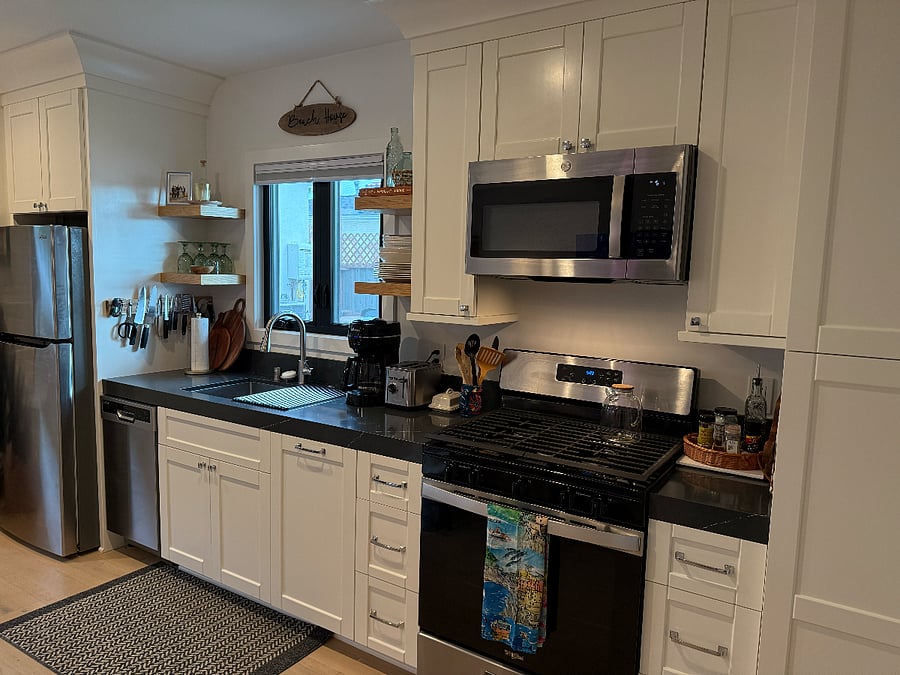 kitchen with regular gas stove, microwave, refrigerator and mini dishwasher