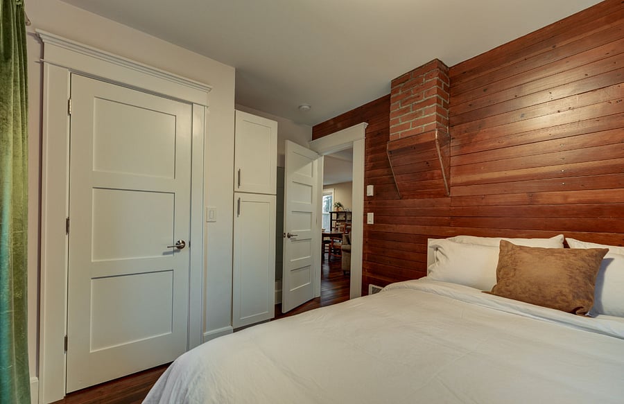 Another view of second bedroom of closet and storage space. Full length mirror behind door.