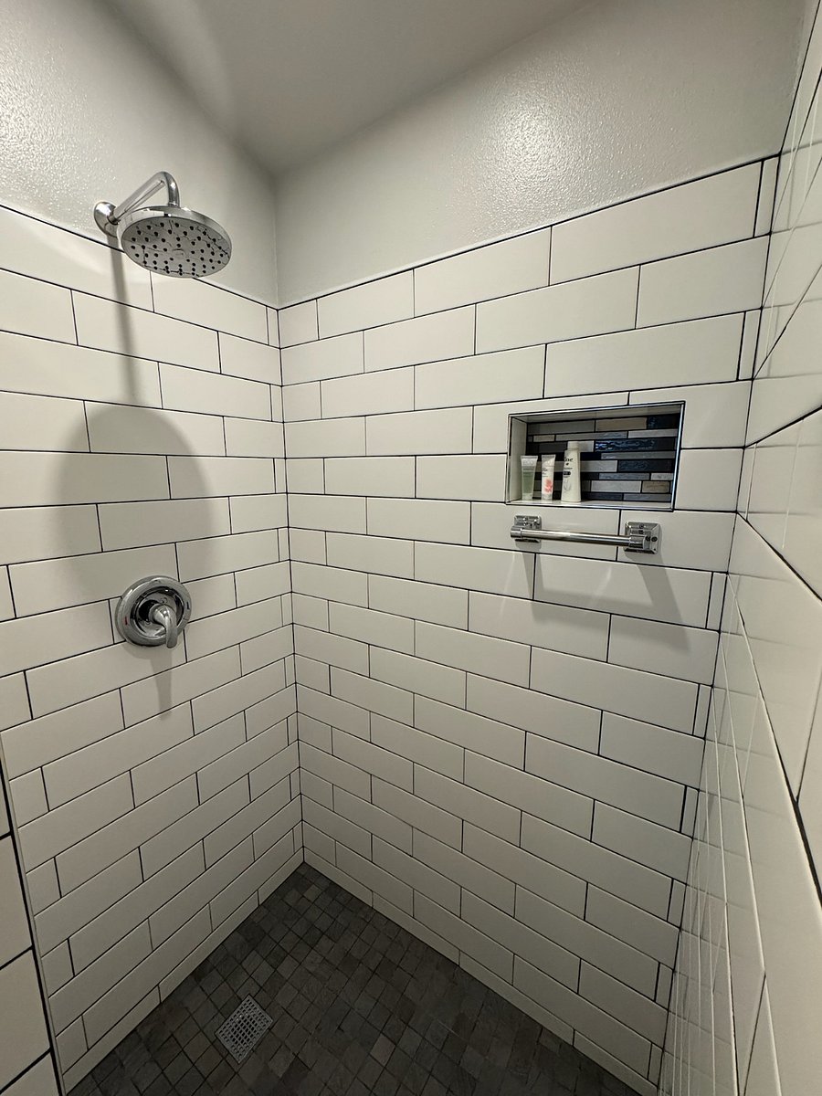 An on-demand water heater provides instant comfort under a rain shower. 
