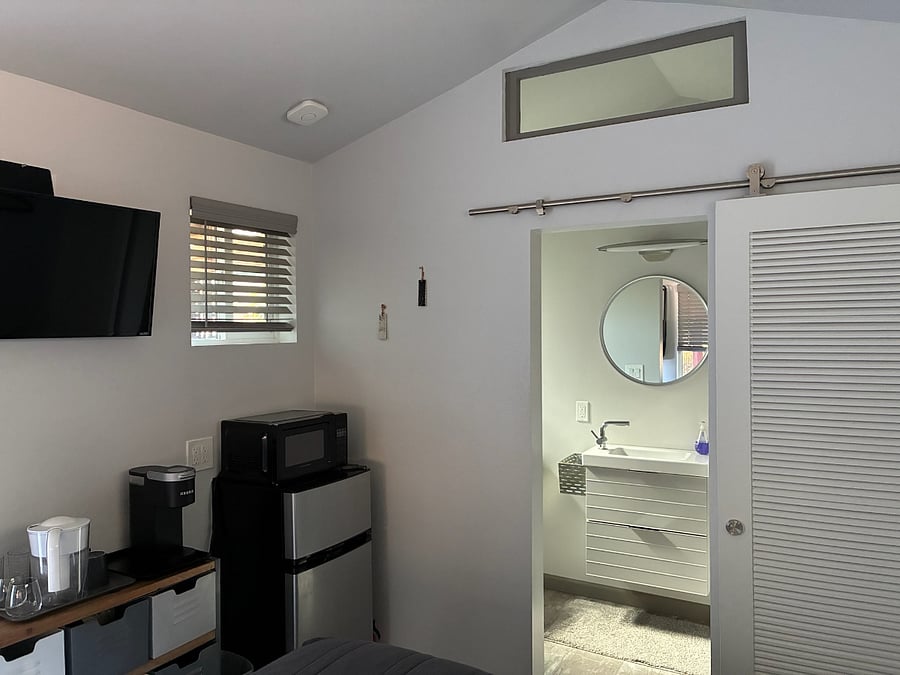Custom-crafted Panama barn door provides privacy in the bathroom. 