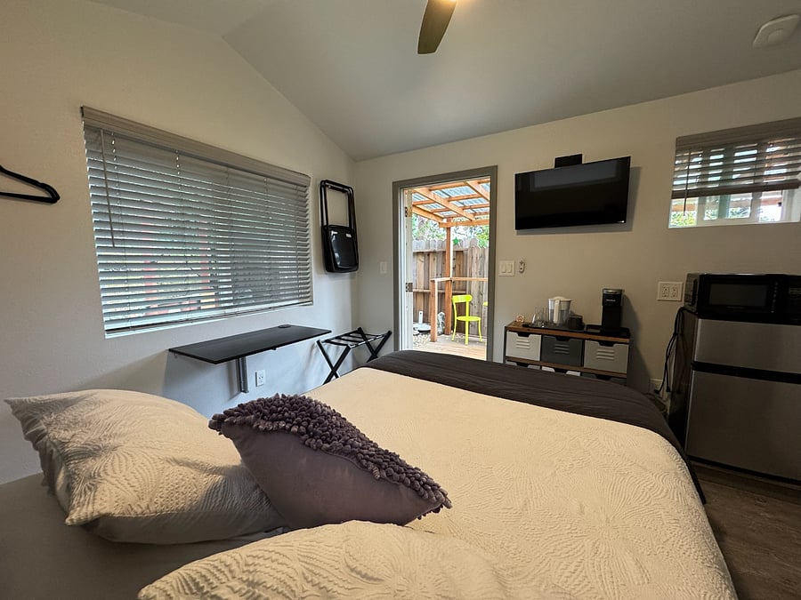Plenty of natural light, with darkening blinds and vertical hooks for hanging clothes.