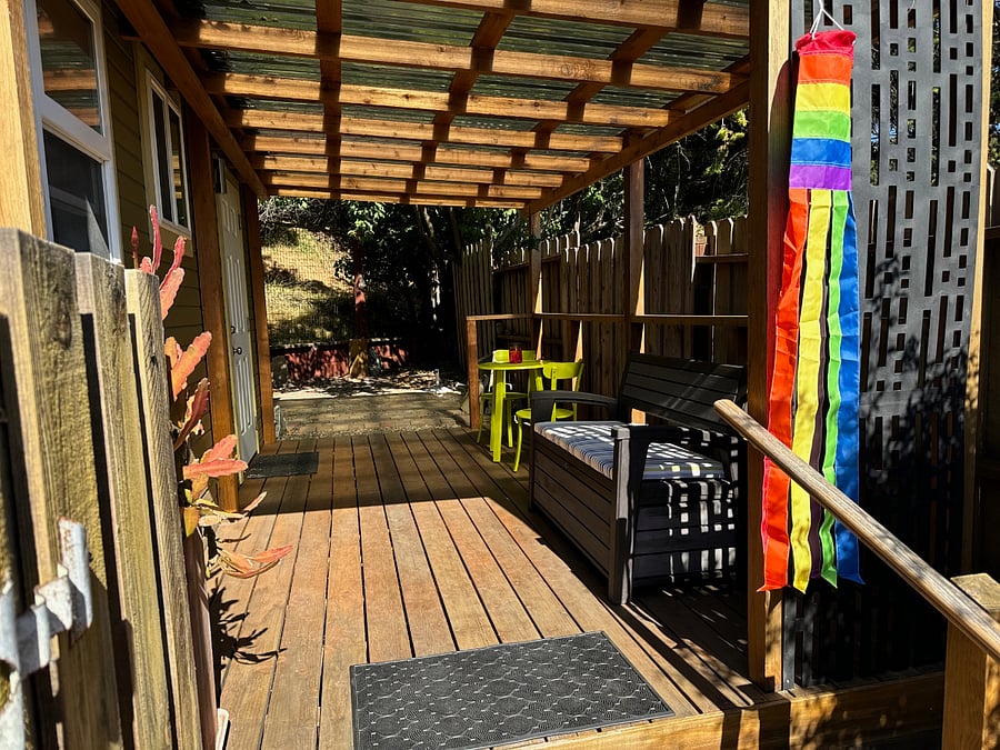 three steps up and you are in a covered deck that provides plenty of outside space to relax