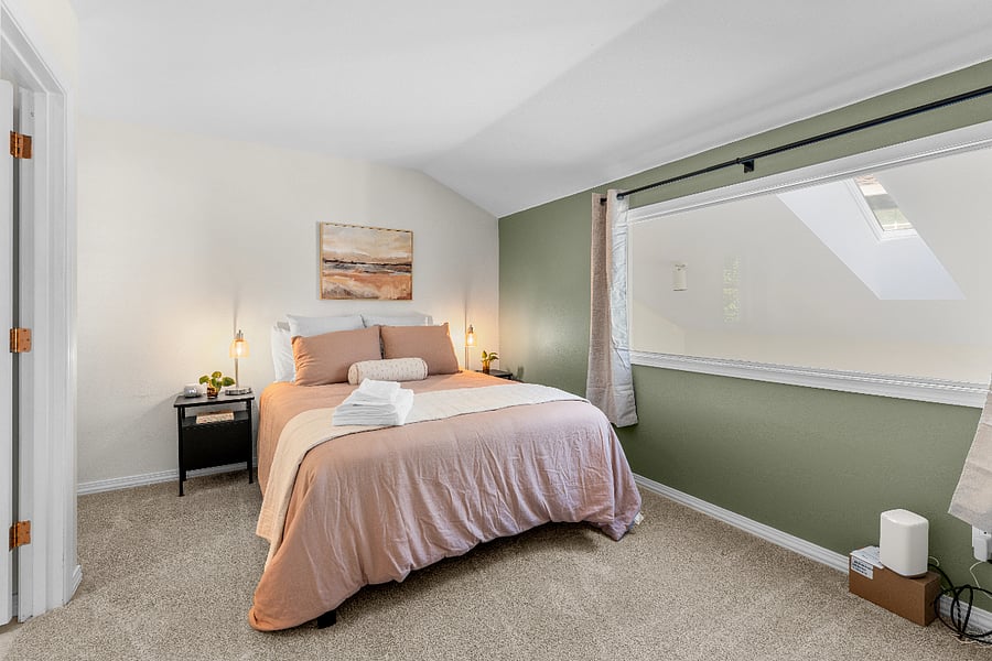 Comfortable second bedroom with queen-sized bed and plenty of natural light. A desk can be added for remote work upon request