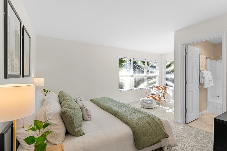 Primary bedroom with queen bed, ensuite bath, and plenty of closet space.