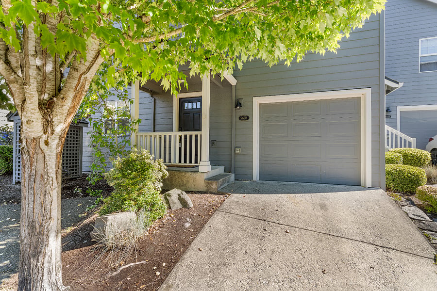Front view of the home with a deep one-car garage offering extra storage space and a chest freezer. Includes remote-control garage access and keyless front door entry for easy arrivals.