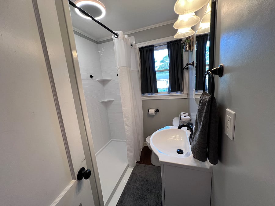 Bathroom with updated walk in shower and linen closet. 